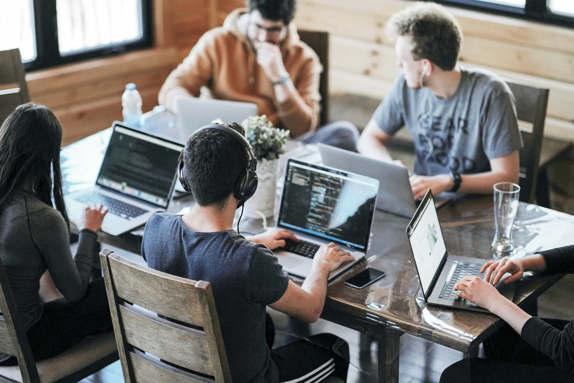 Hands holding a smartphone over a desk, building a Jira bug-tracking workflow